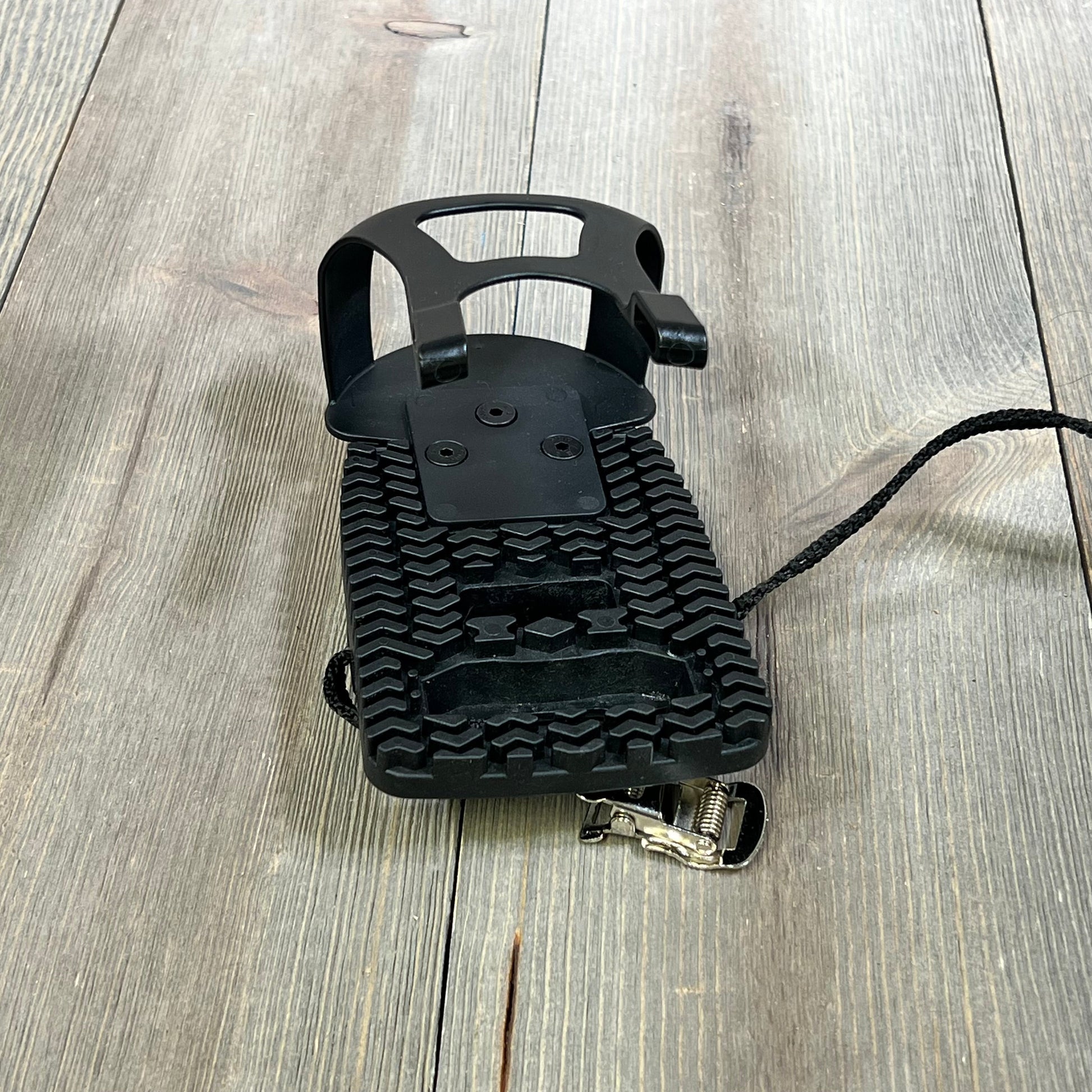 Black Kelecuia toe cage pedal adapter for Peloton bike, featuring durable straps and textured grip for regular shoes.
