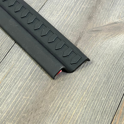 Black thermoplastic entry guard for Jeep Wrangler TJ/LJ, textured design, no-drill installation, durable protection.
