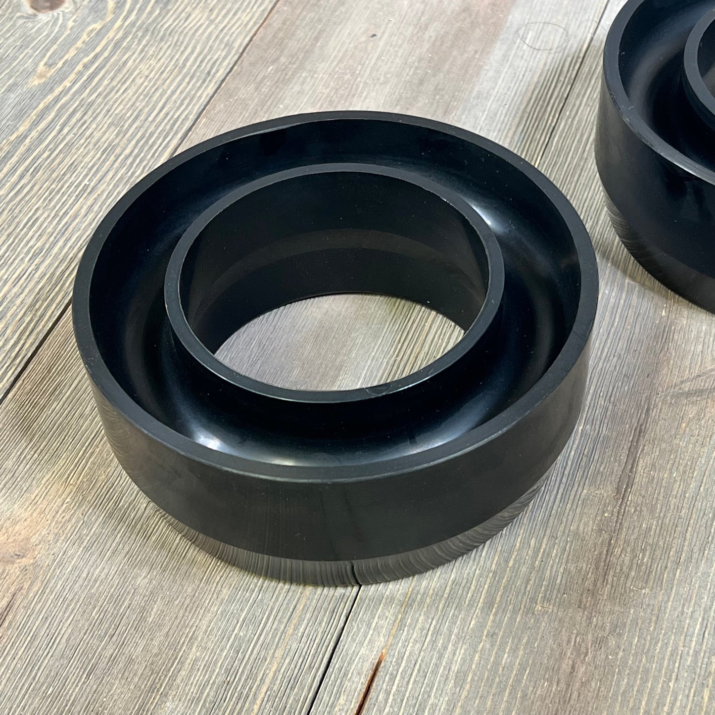 Polyurethane coil spring spacer from Dynofit 3" lift kit for 1999-2006 Chevy Silverado 1500 and GMC Sierra 1500 2WD.