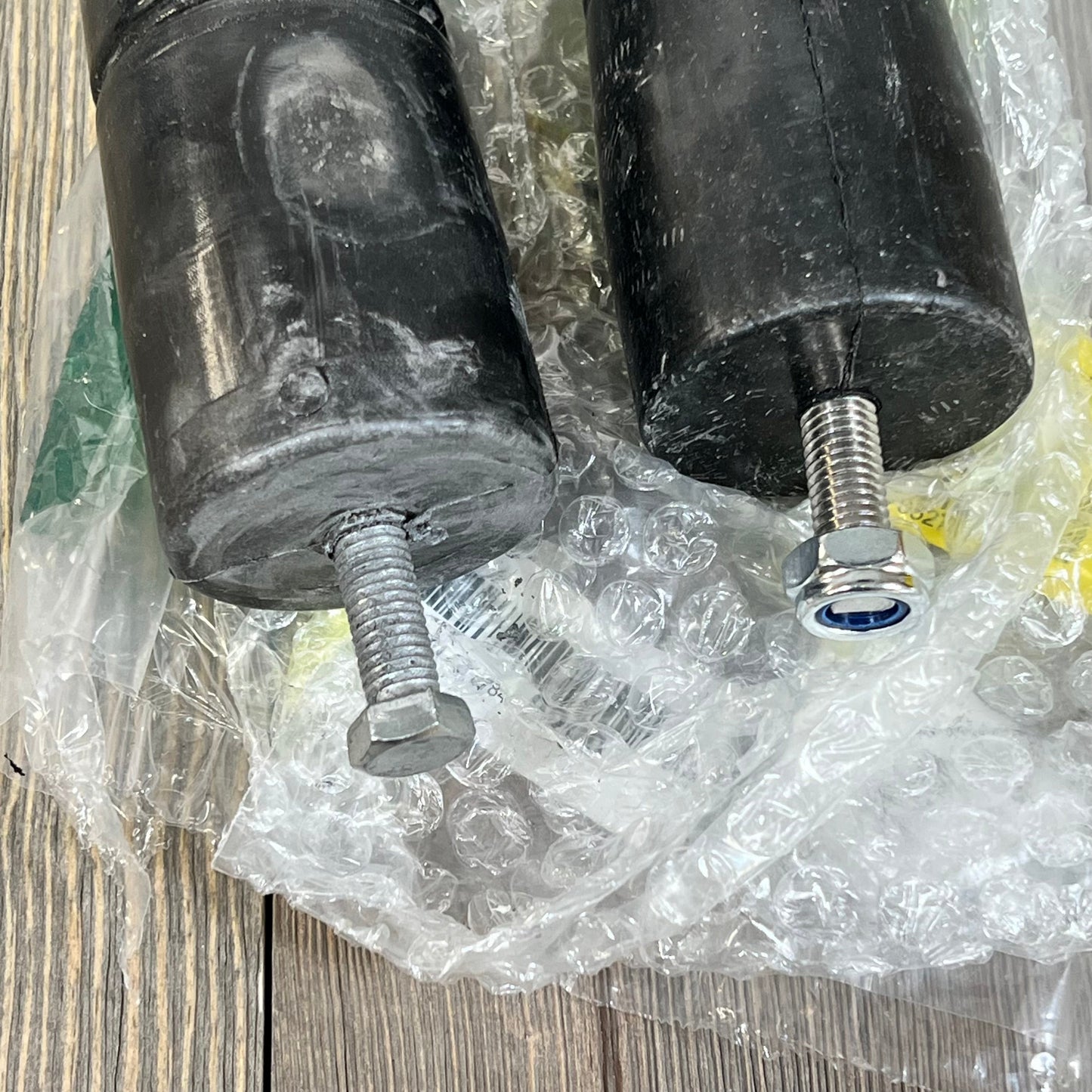Bolt-in extended polyurethane bump stops for Jeep TJ Wrangler 1997-2006, shown with bolts and protective packaging.