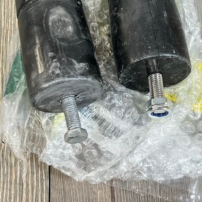 Bolt-in extended polyurethane bump stops for Jeep TJ Wrangler 1997-2006, shown with bolts and protective packaging.