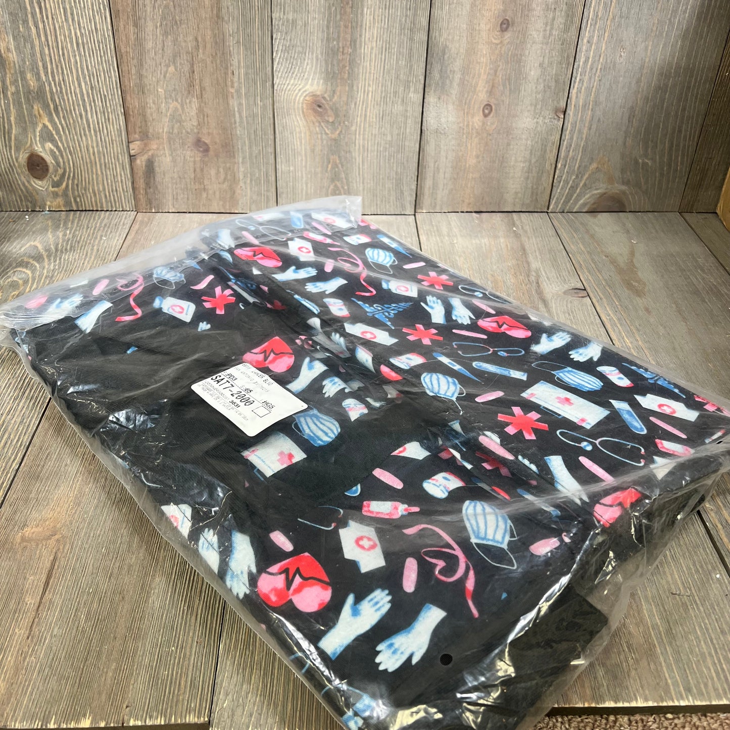 Waterproof nurse bag with colorful medical-themed print, perfect for nursing students. Multiple pockets for easy organization.