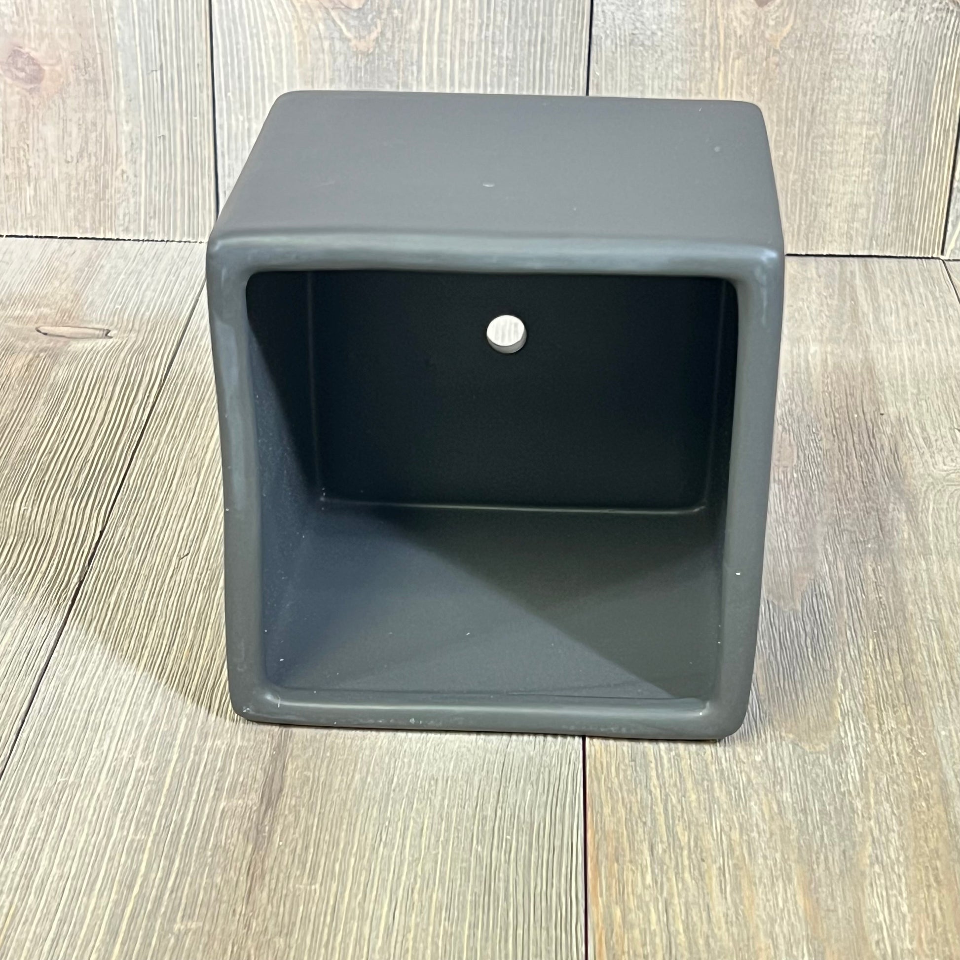 Modern black ceramic square plant pot on wooden floor, ideal for small succulents, part of a decorative set of 2 planters.