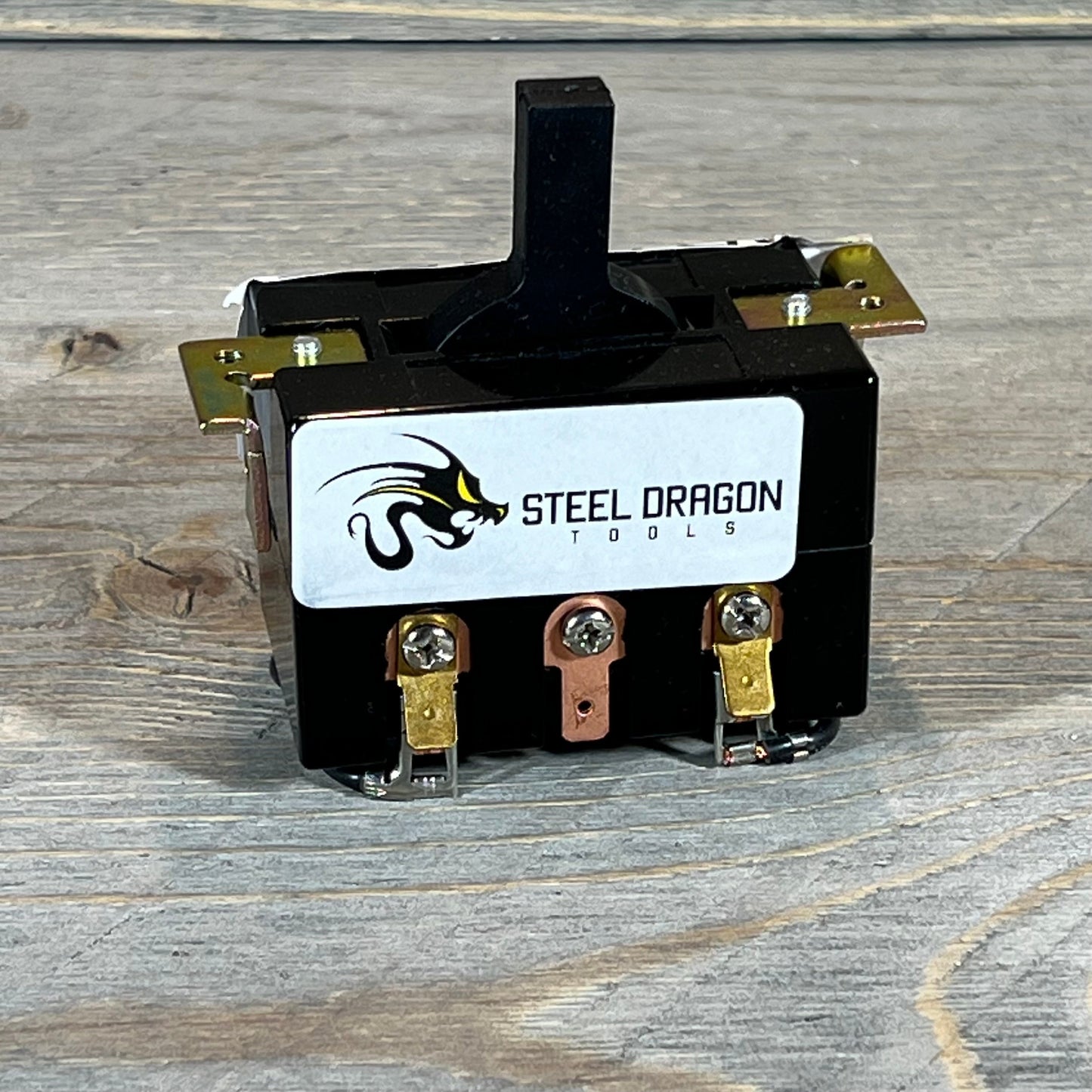 Black Steel Dragon Tools switch for Ridgid 300 and 535, featuring durable metal connectors on a wooden surface.