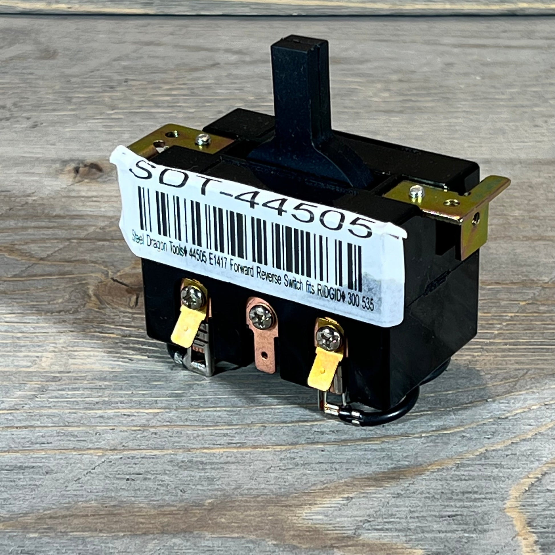 Black Steel Dragon Tools switch for Ridgid 300 and 535 machines on wooden surface, showing connectors and barcode.
