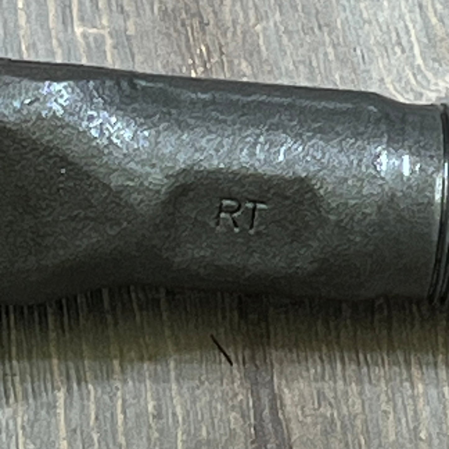 Close-up of MOOG ES3625 Steering Tie Rod End for Dodge Ram 2500, showing sturdy black metal finish and engraved "RT" detail.