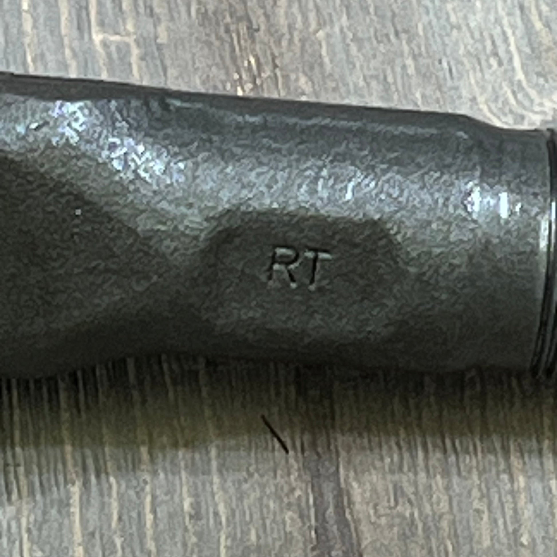 Close-up of MOOG ES3625 Steering Tie Rod End for Dodge Ram 2500, showing sturdy black metal finish and engraved "RT" detail.