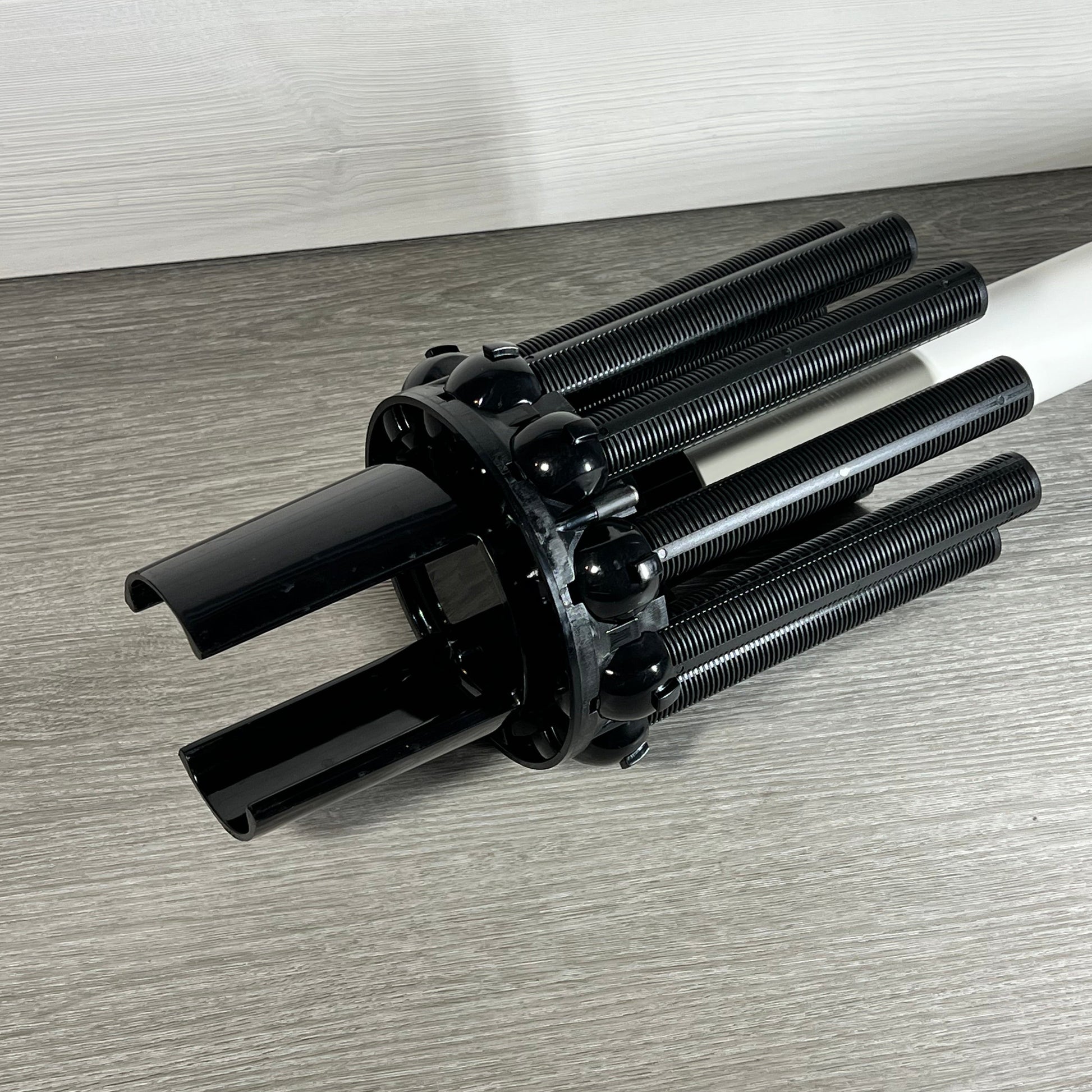 Black Tiroar SX244DA lateral assembly with center pipe, designed for Hayward filters on a wooden surface.