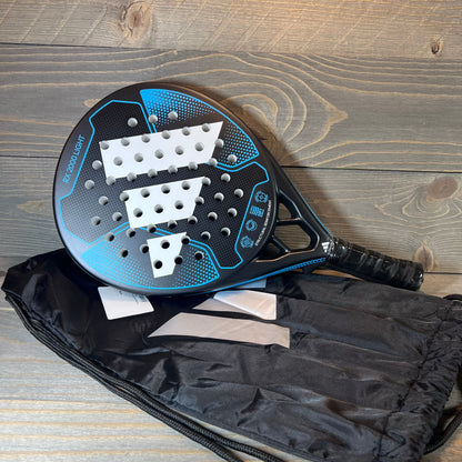Blue Adidas RX 2000 Light padel racket on wooden surface with black carry bag, showcasing sleek design and grip.