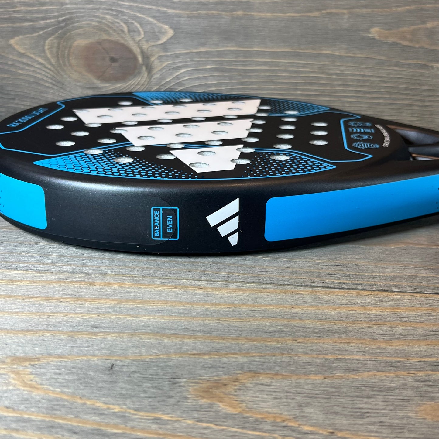 Blue Adidas Rx 2000 Light padel racket with sleek design, featuring prominent white logo on textured surface.
