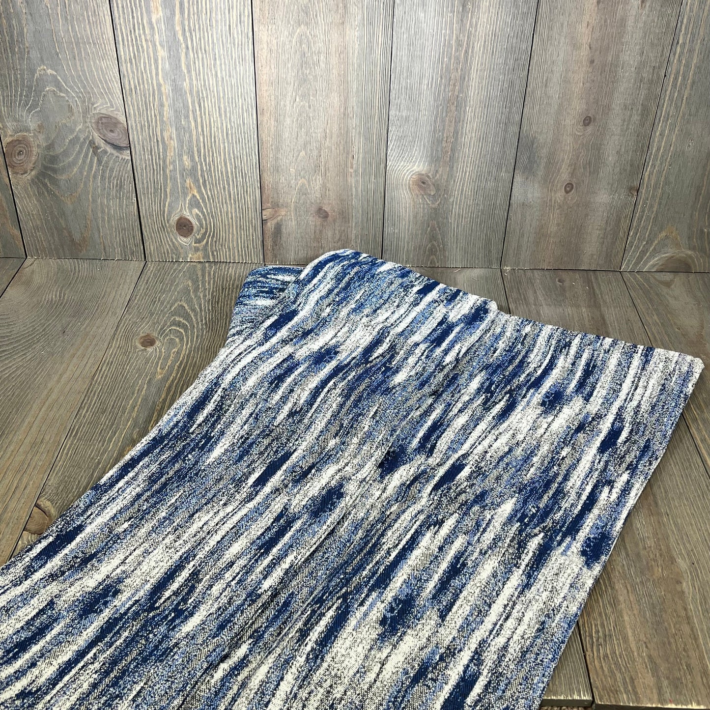 Navy blue abstract textured 24x24 pillow covers on wooden background, ideal for couch decor and home styling.