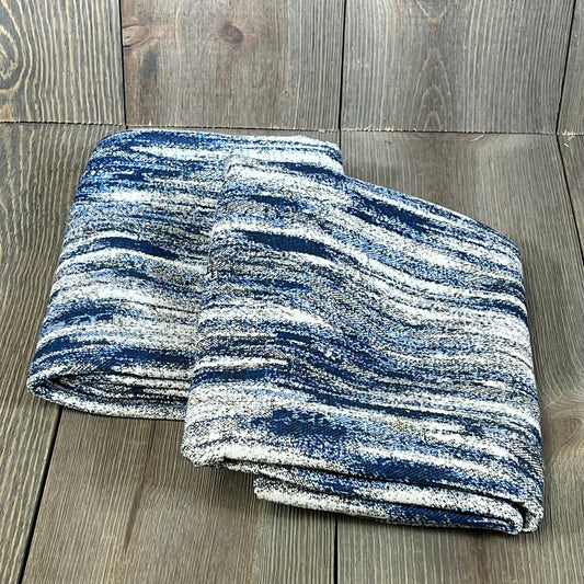 Navy blue abstract textured 24x24 pillow covers folded on wooden surface, ideal for modern couch decor.