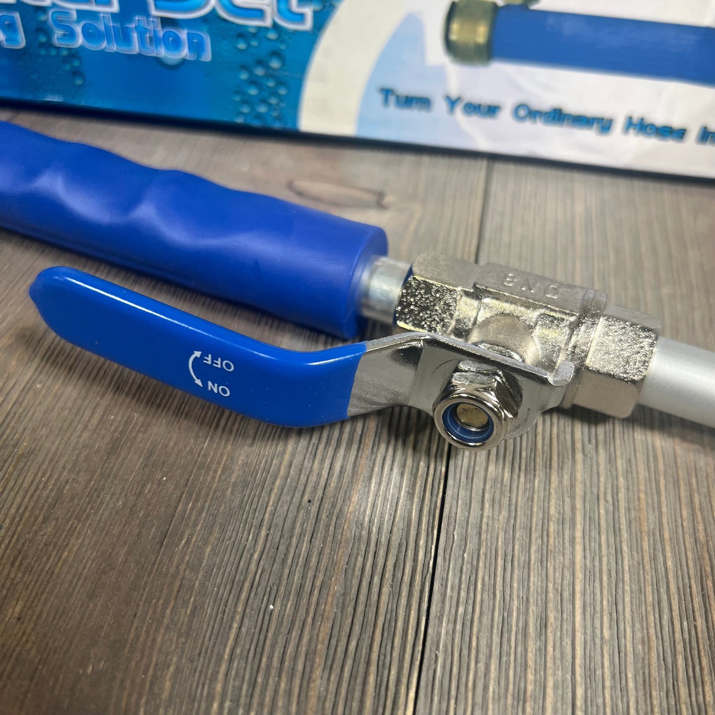 Blue Rerennco nozzle with hose quick connector, showcasing durable metal construction for efficient garden watering.