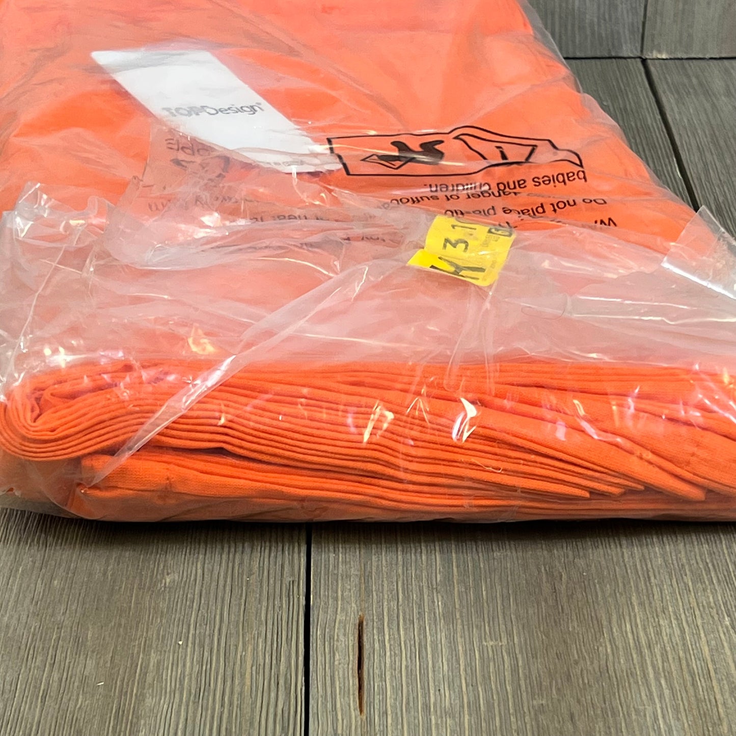 Pack of 12 orange cotton tote bags in clear packaging, ideal for DIY, promotions, and reusable grocery shopping.