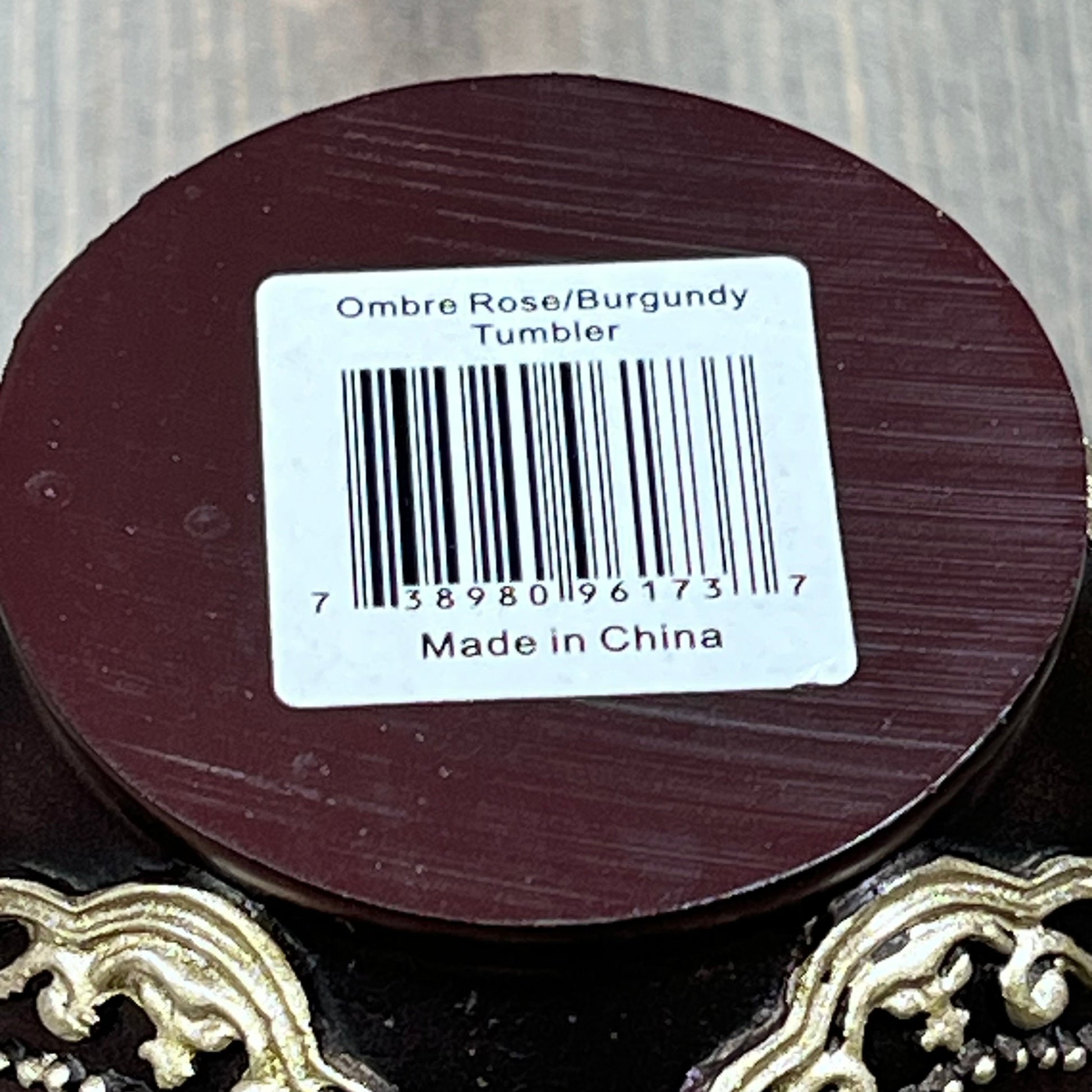 Burgundy base of Popular Bath Ombre Rose Tumbler with barcode and "Made in China" label.