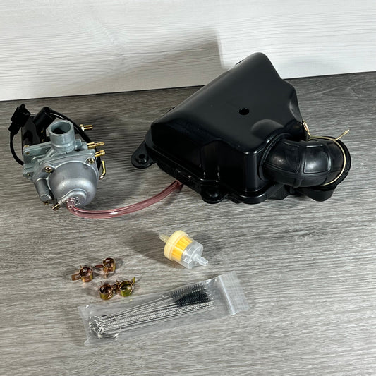 Carburetor and air filter set for Polaris Sportsman, Scrambler, Predator with accessories on wooden surface.