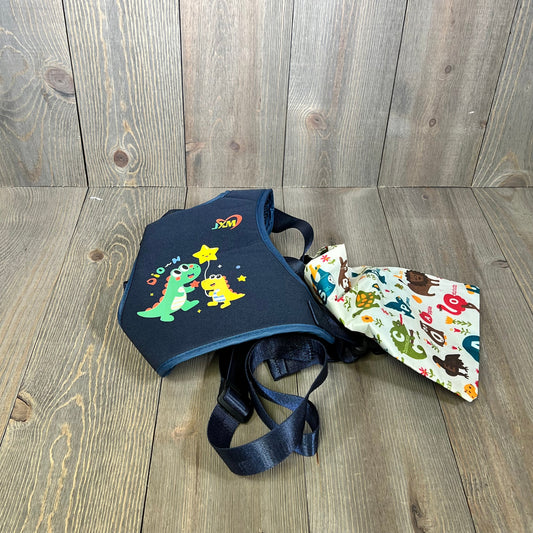 Colorful children's safety harness with cute dinosaur design, adjustable straps, and autism awareness fabric for ages 3-6.