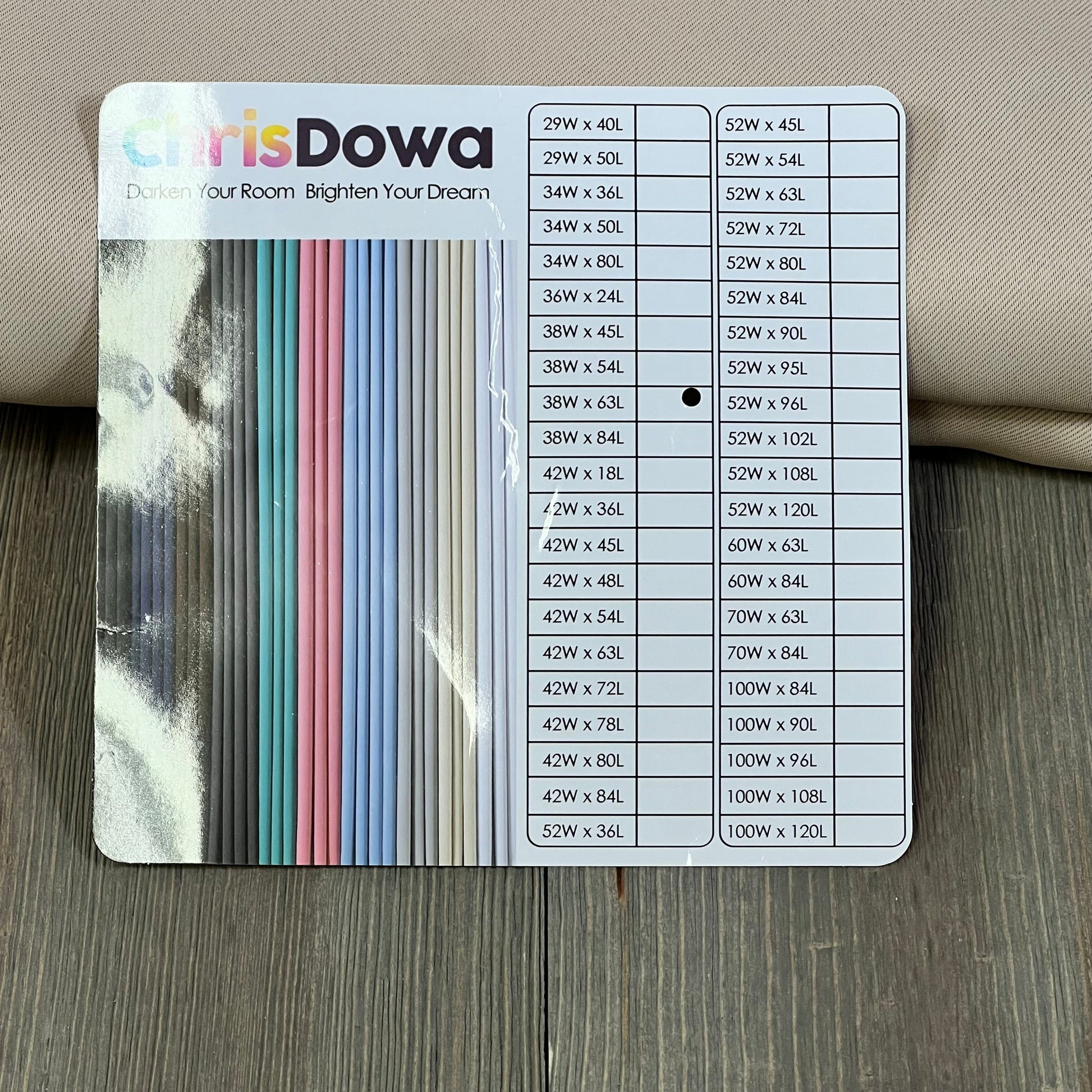 ChrisDowa blackout curtains size chart displayed on a wooden surface, showcasing various dimensions and color options.