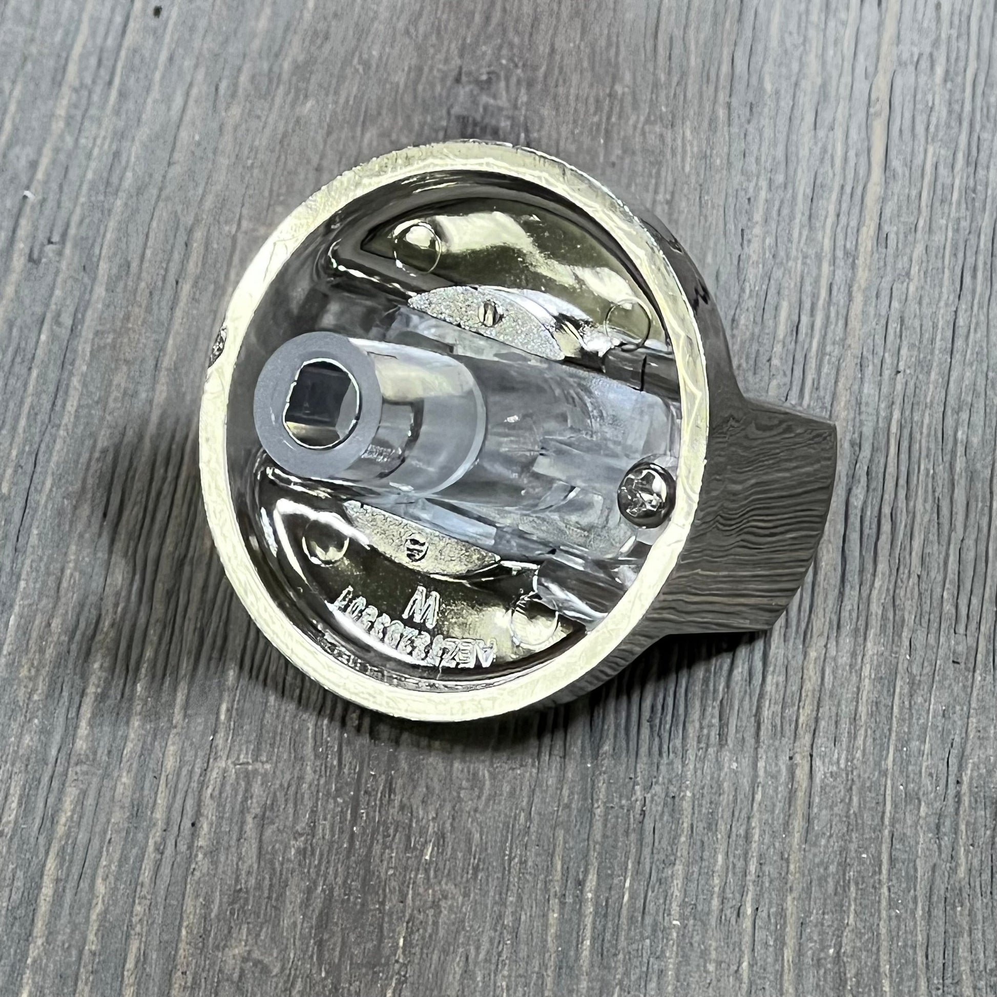 Bottom view of replacement burner control dial stove knob for LG gas cooktop, showcasing high-quality metal finish.