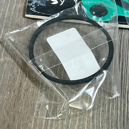Piston ring for Kawasaki KX85 2001-2013, shown in protective packaging on a wooden surface.