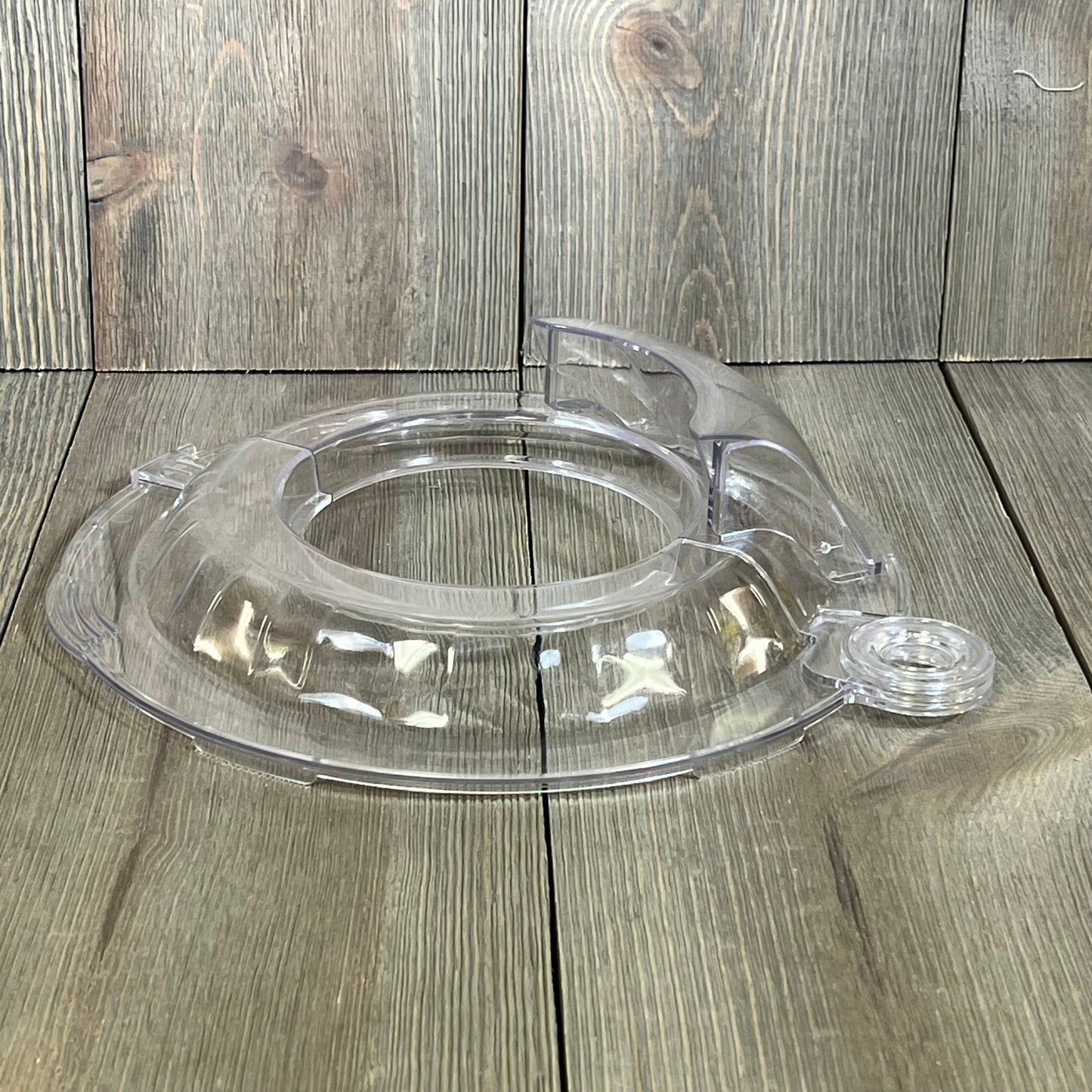Pouring shield for KitchenAid Tilt Head 4.5-5QT mixer, clear splatter guard accessory on wood background.