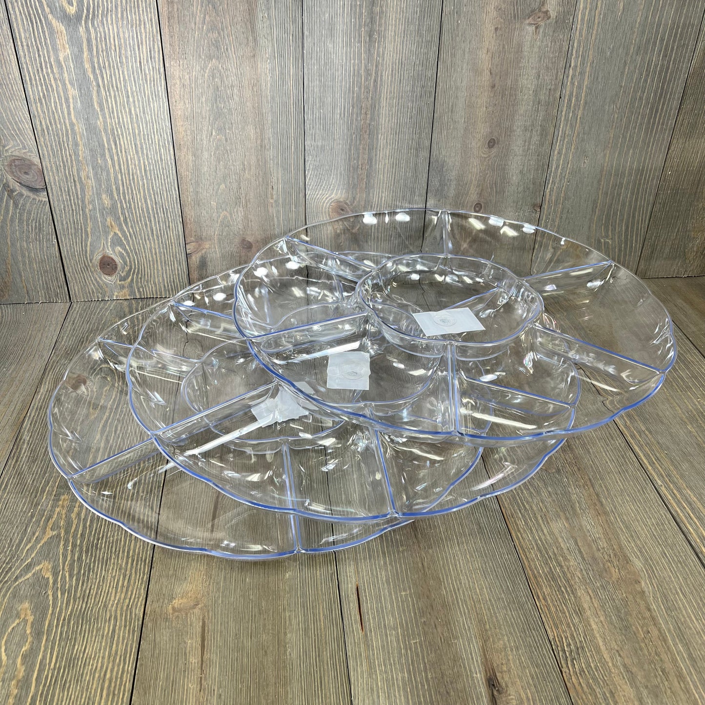 Clear hard plastic round serving tray with seven sections, perfect for parties. Durable and elegant design for entertaining.