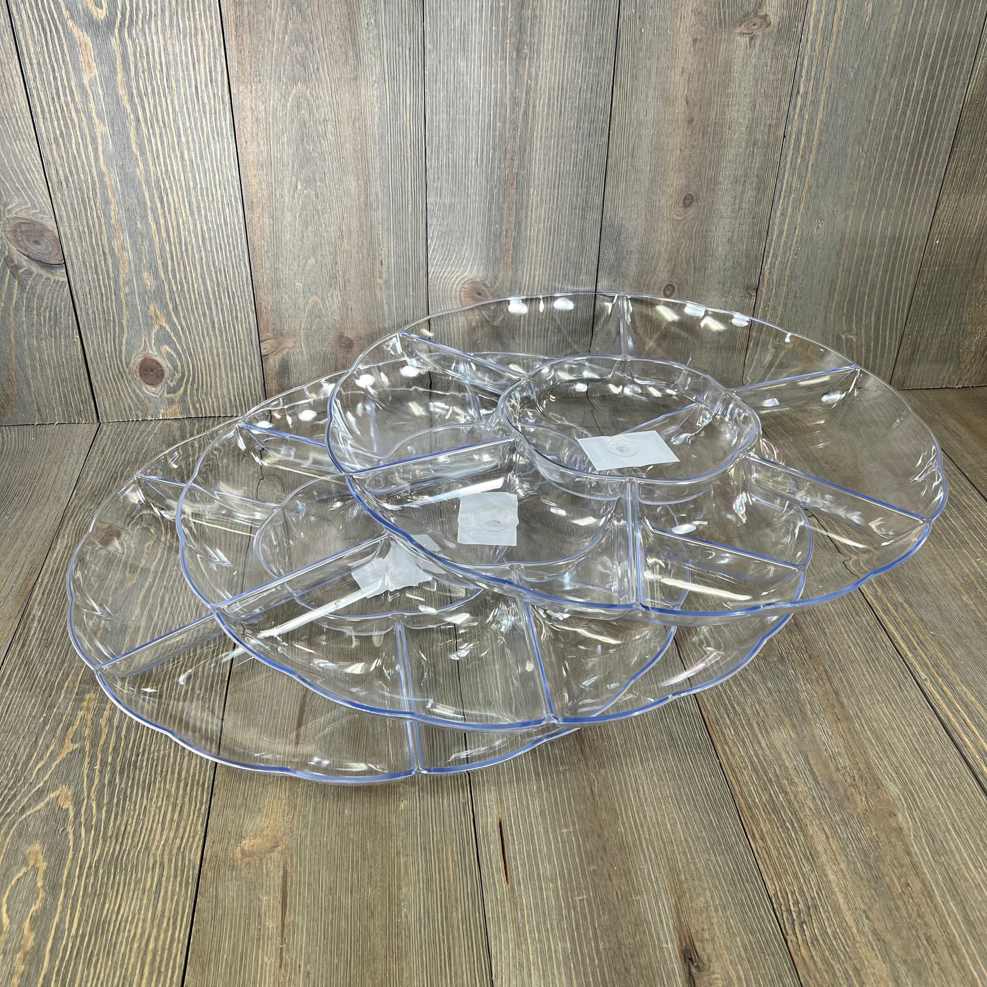 Clear hard plastic round serving tray with seven sections, perfect for parties. Durable and elegant design for entertaining.