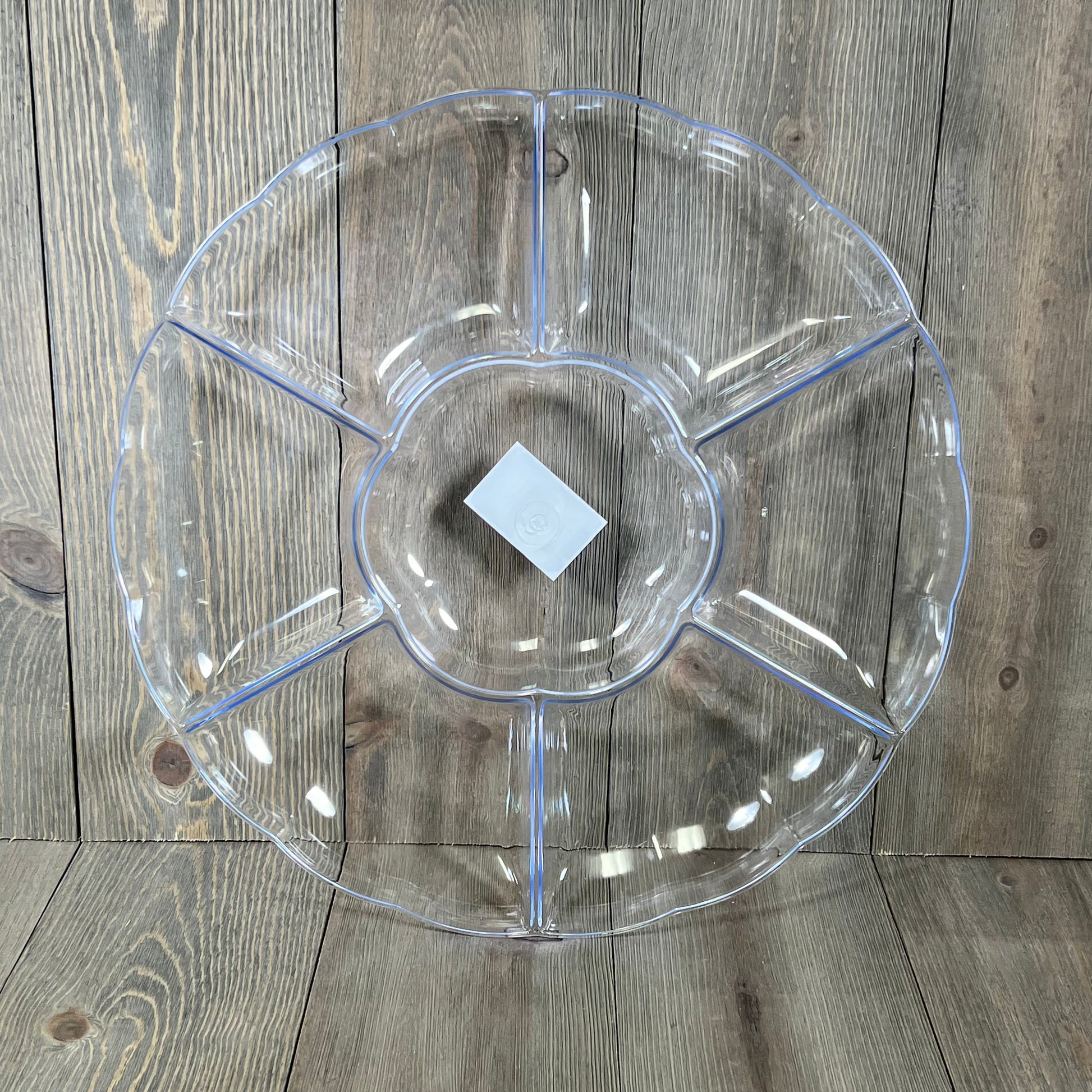 Clear hard plastic round serving tray with seven sections, perfect for parties, 16-inch diameter, three-count set.
