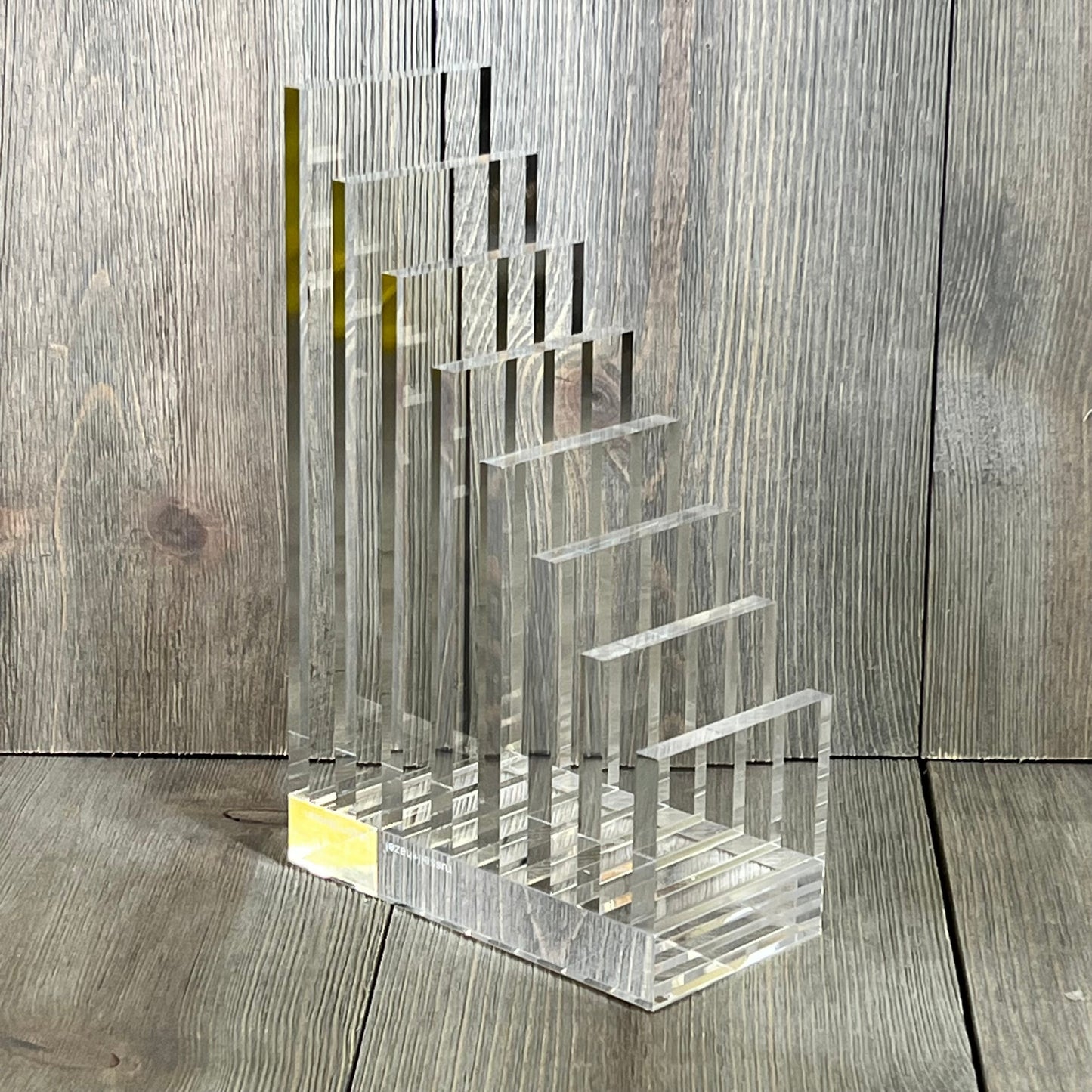 Clear acrylic collator and bookend by Russell+Hazel, perfect for organizing books, size 5” x 8” x 2.5”, modern design.