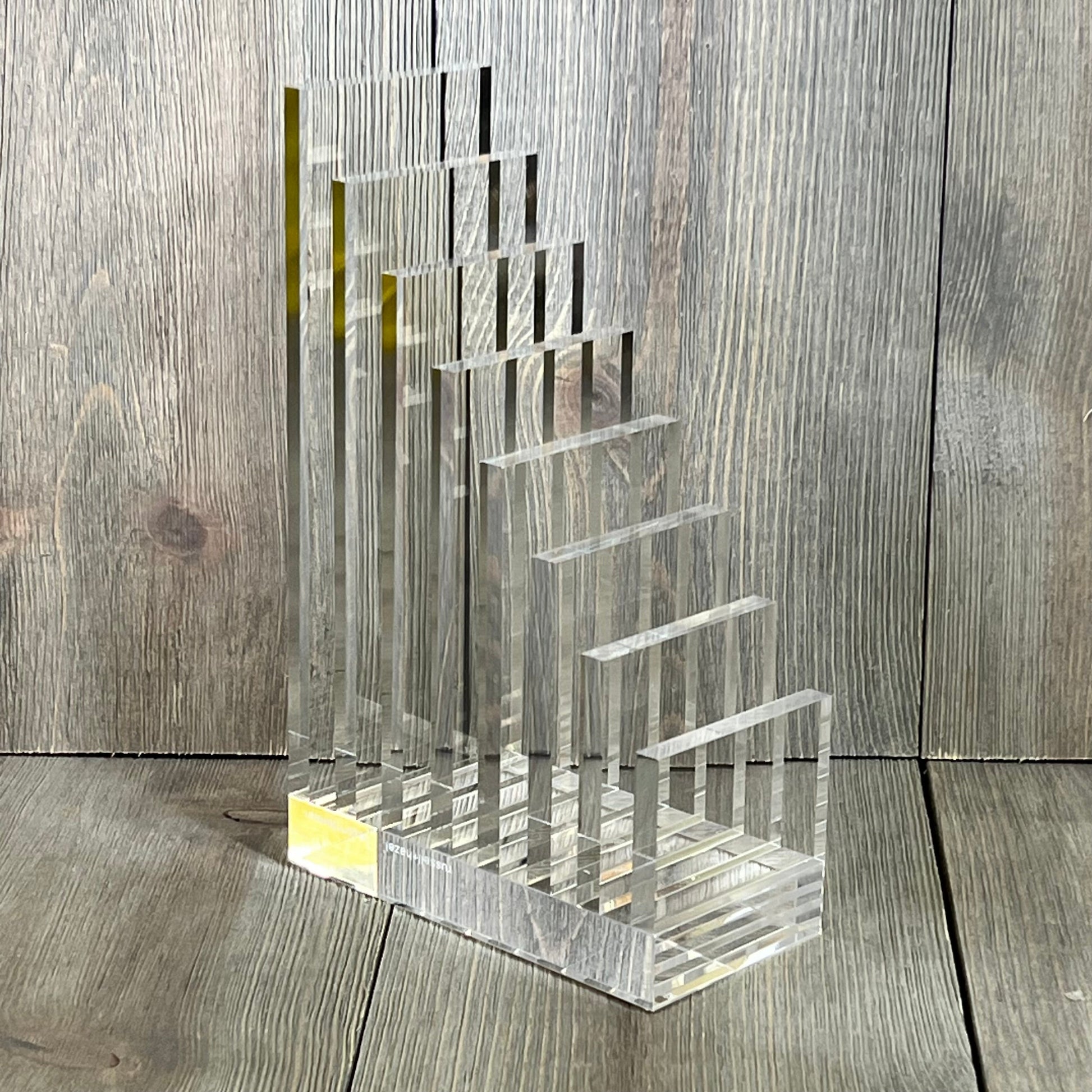 Clear acrylic collator and bookend by Russell+Hazel, perfect for organizing books, size 5” x 8” x 2.5”, modern design.