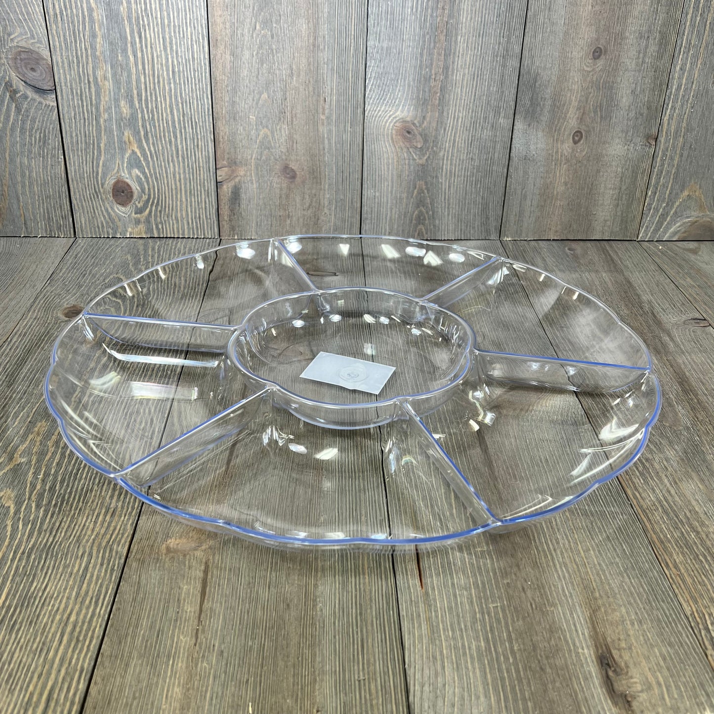 Clear 16-inch round serving tray with 7 sections, perfect for parties. Durable hard plastic, ideal for appetizers or snacks.