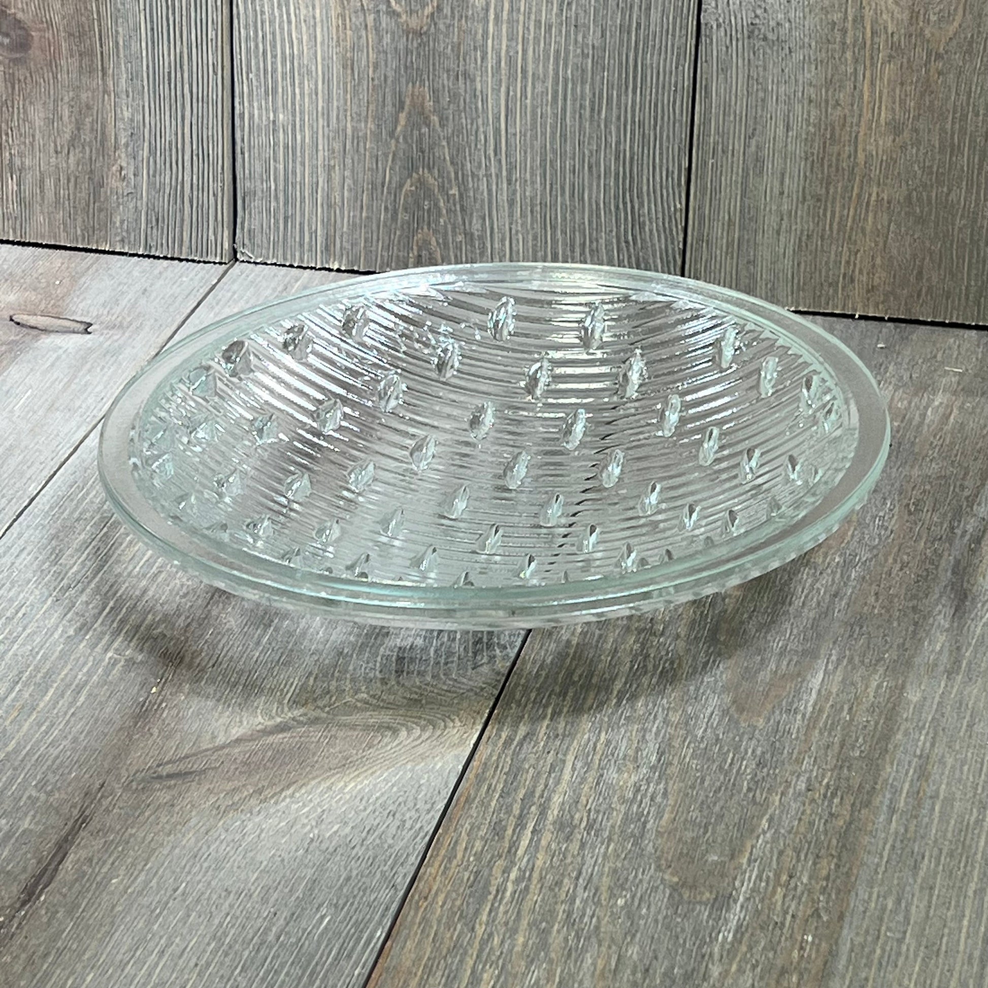 Tempered clear lens for Hayward underwater lights, 7-9/16 inches in diameter, resting on a wooden surface.