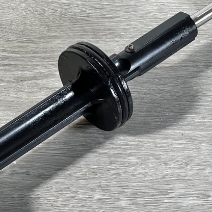 Close-up of 1045743403-GUOJINJISM handle and piston assembly showing sleek black finish on gray surface.