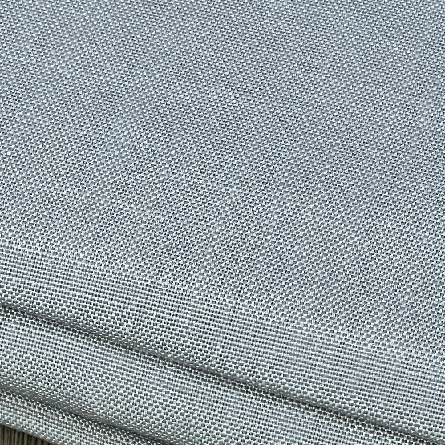 Linen-textured grey tablecloth, wrinkle-free and spill-proof, showcasing premium fabric quality for dining elegance.