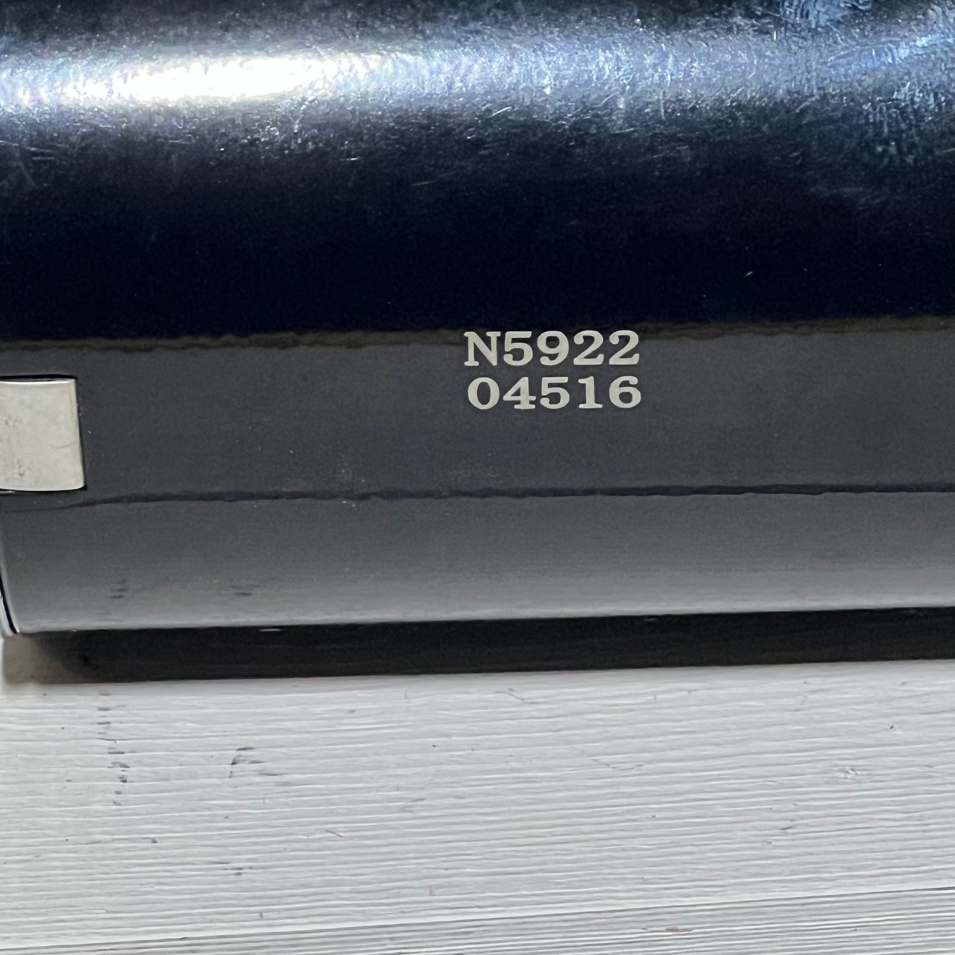 Close-up of a starter replacement part for Kawasaki engines, featuring serial number N5922 04516 on a metallic surface.