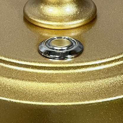 Close-up of gold rechargeable table lamp base with touch control button, featuring sleek metallic finish for modern decor.