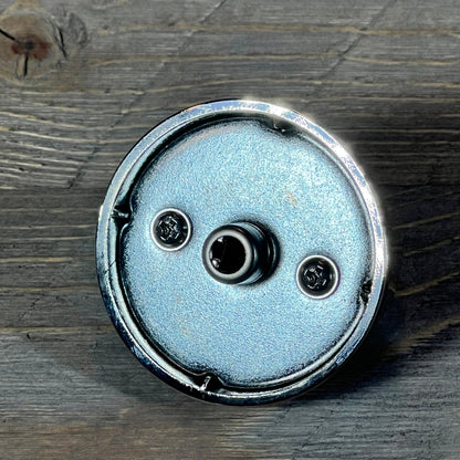 Close-up of a Samsung gas stove burner control knob, metallic finish, viewed from the back, highlighting attachment points.