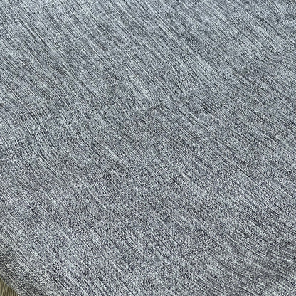 Grey textured linen tablecloth close-up, showcasing waterproof and wrinkle-free fabric for kitchen and event decor.