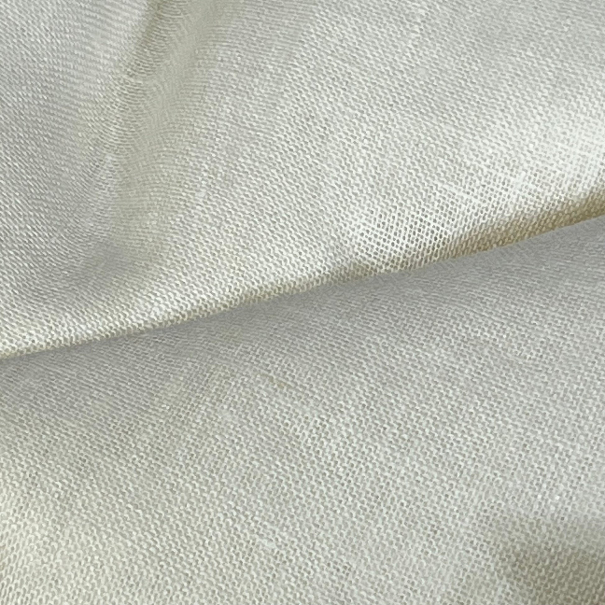 Close-up of Solino Home ivory linen sheer curtain fabric, showcasing the fine European flax texture and light filtering quality.