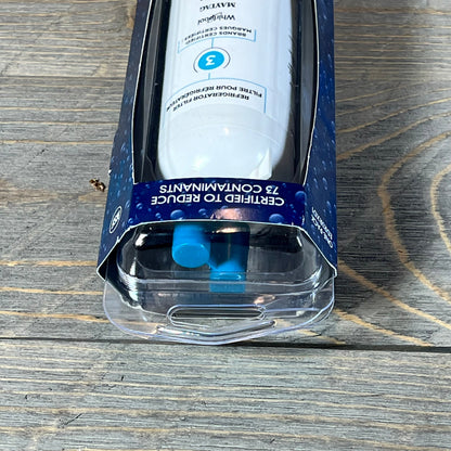 Close-up of everydrop® by Whirlpool Ice and Water Refrigerator Filter 3 in packaging on a wooden surface.