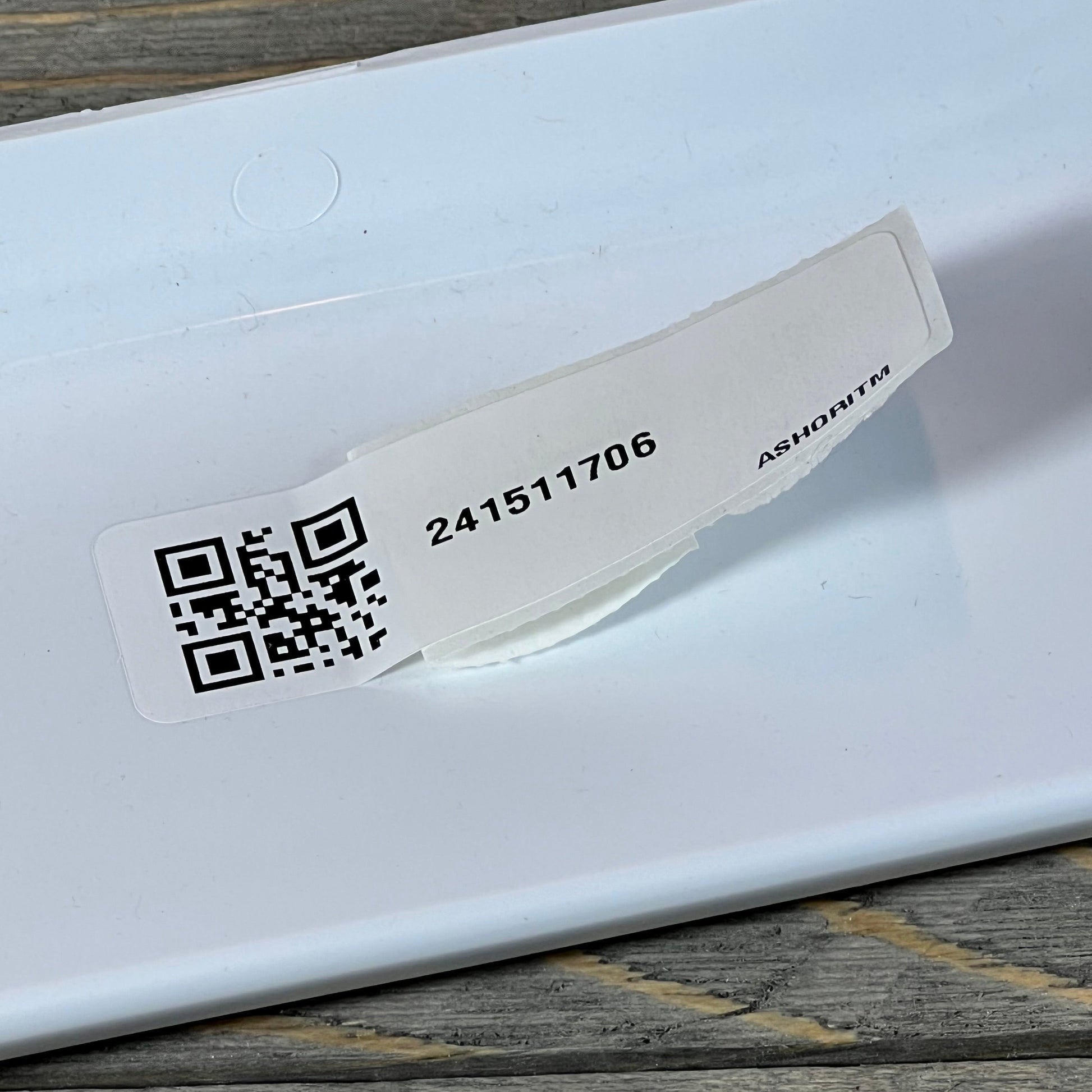 Close-up of Frigidaire 241511706 refrigerator door shelf bin with QR code and product number sticker.