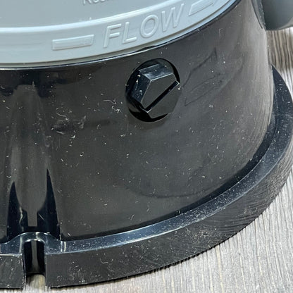 Close-up of Hayward CL200 chlorinator base showing flow direction and durable ABS material.