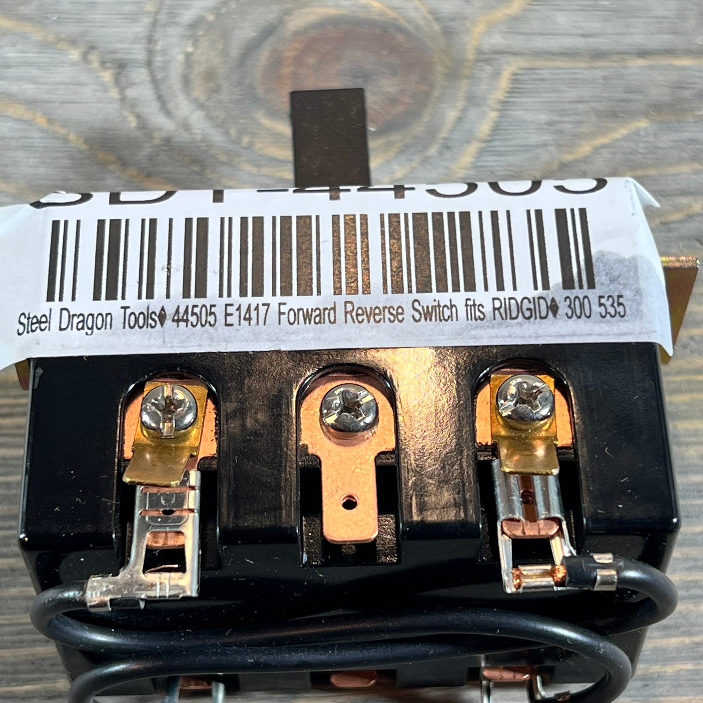 Close-up of Steel Dragon Tools forward reverse switch for Ridgid 300 and 535, showing detailed connectors and barcode.