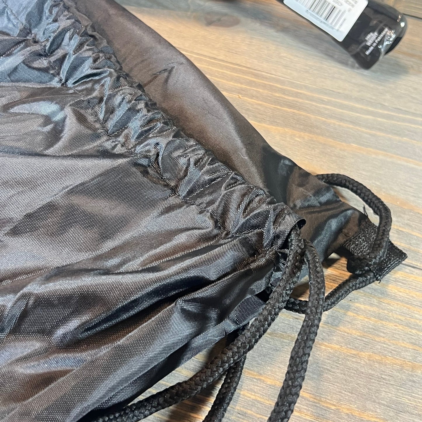 Close-up of the Adidas Rx 2000 Light padel racket's black drawstring cover, showcasing its durable material.