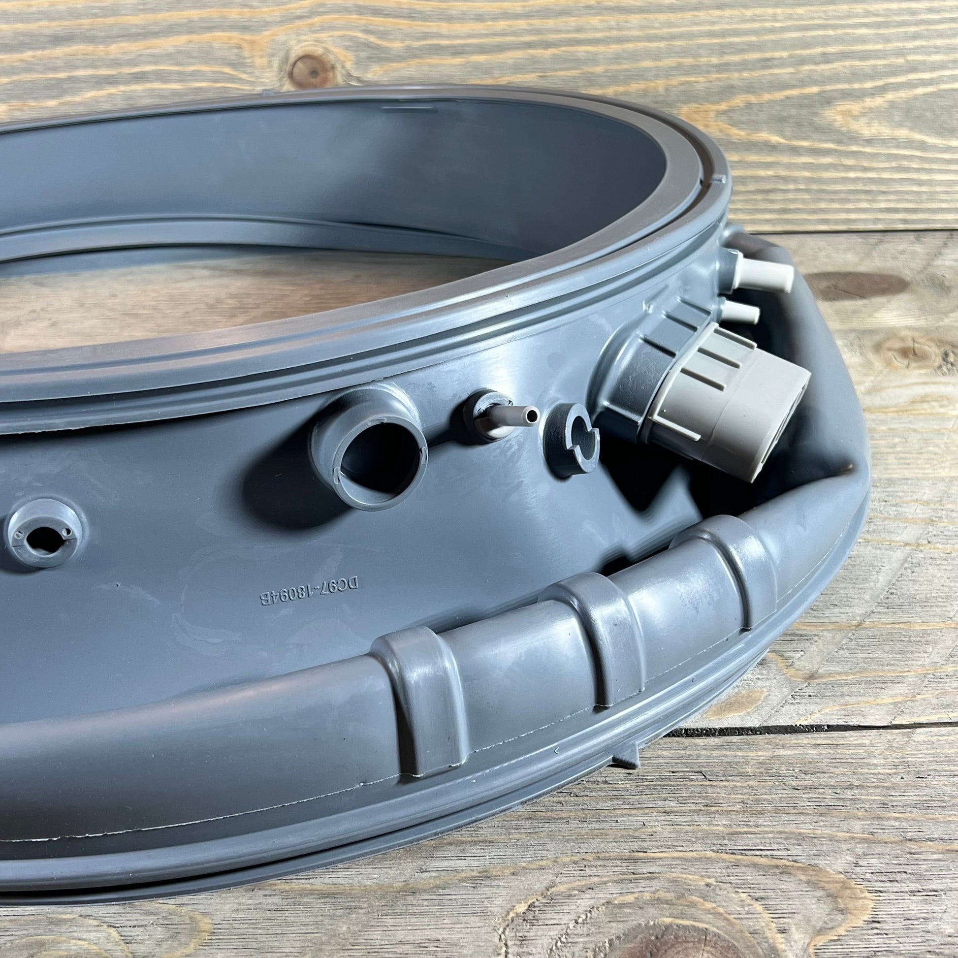Close-up of the DC97-18094B door boot gasket for Samsung washer, showing durable waterproof material and connectors.
