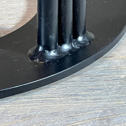 Close-up of the durable metal base of the 1048539768 wood splitter wedge resting on a wooden surface.