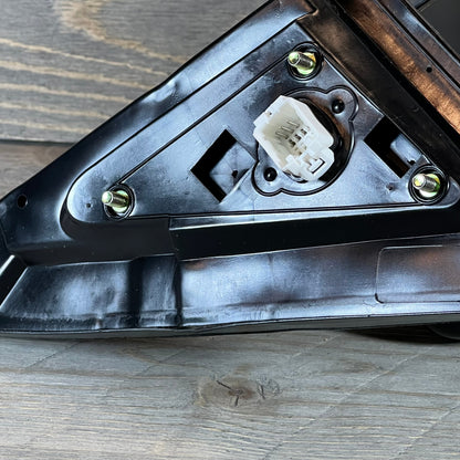 Close-up of the Honda Accord Coupe driver side door mirror connector, showcasing the mounting hardware and electrical plug.