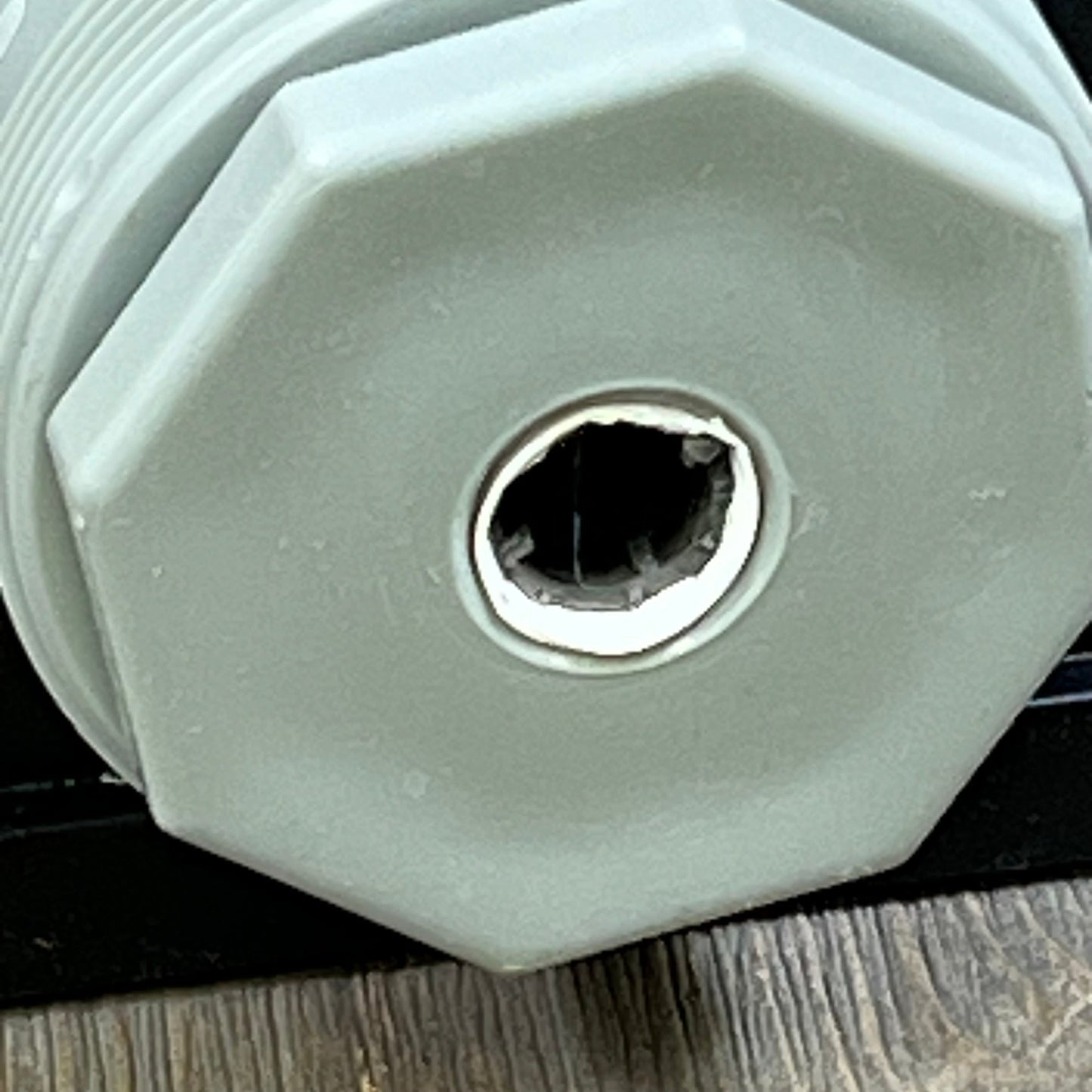 Close-up view of CL220 automatic chlorinator feeder cap showing the threading detail for secure installation.