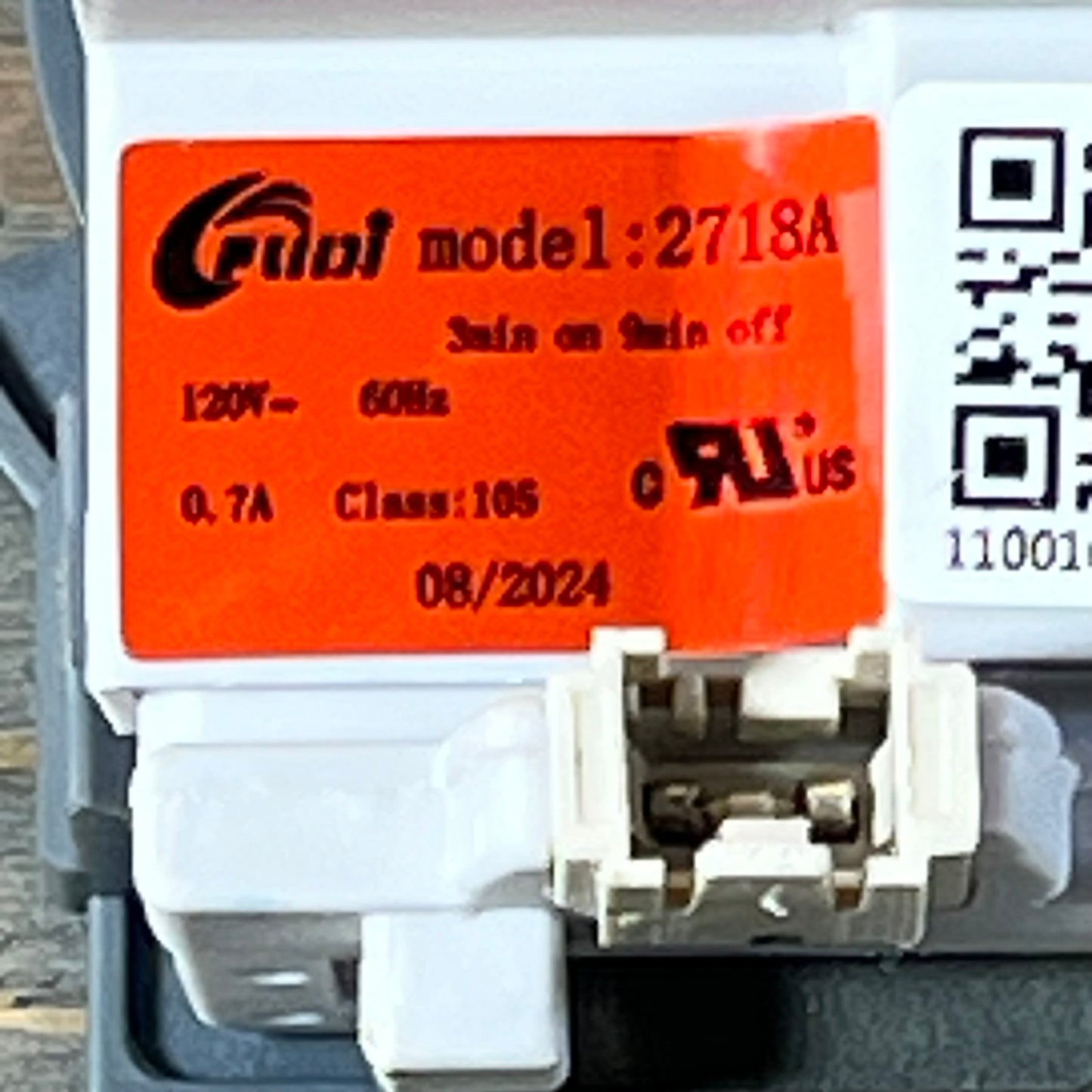 Close-up view of model 2718A dishwasher drain pump assembly label for Kenmore Frigidaire.