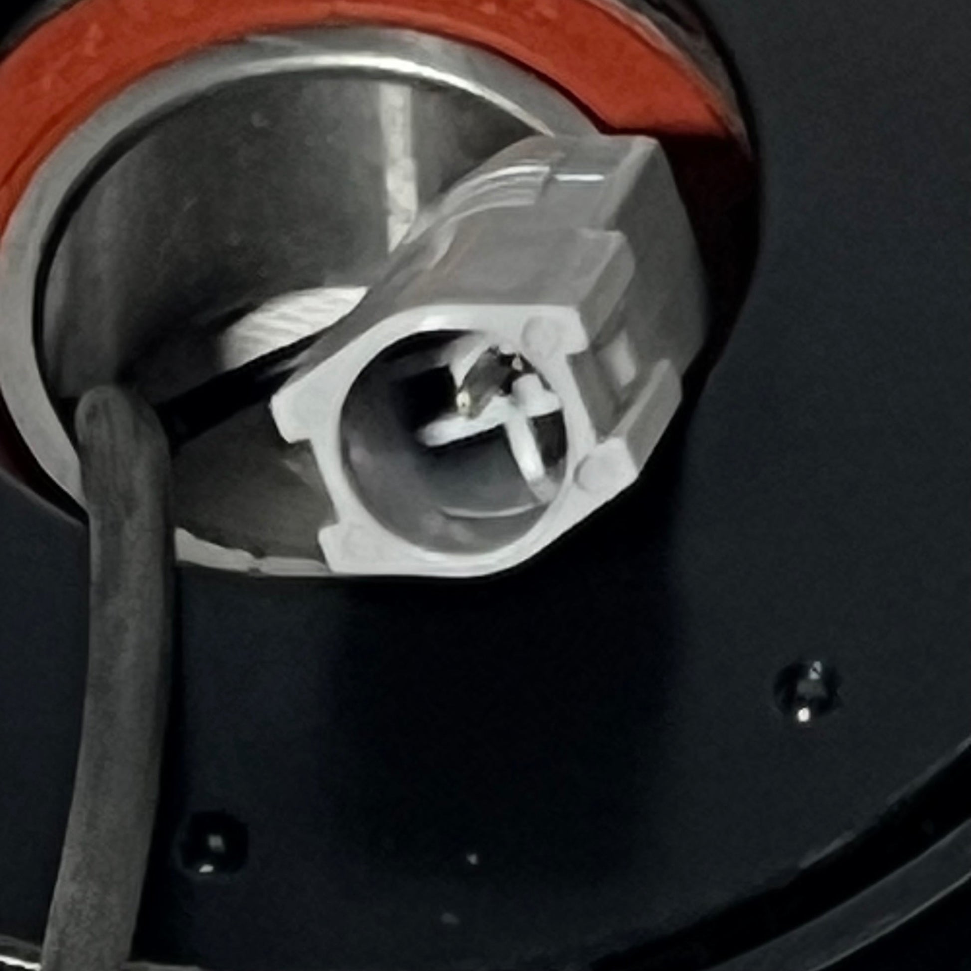 Close-up view of the connector on the 1048525440-uxcell AC Compressor Clutch Set for Mazda 3, 2010-2013 models.
